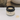 Annmarie Coconut Honey Mask sits open on a white surface with a dollop of product beside it.
