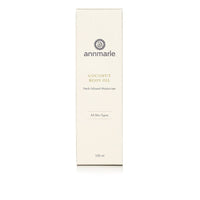Annmarie Coconut Body Oil, a herb-infused moisturizer for all skin types, sits in a white box.
