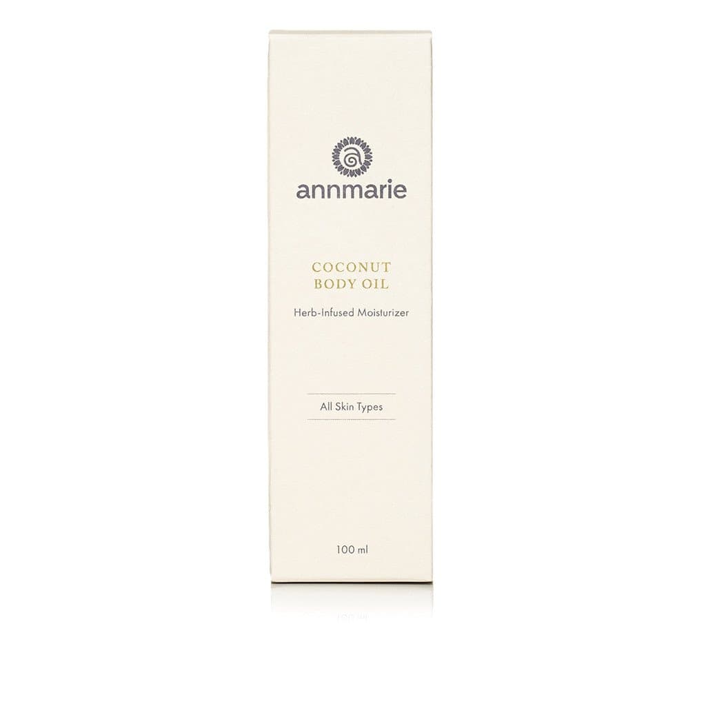 Annmarie Coconut Body Oil, a herb-infused moisturizer for all skin types, sits in a white box.
