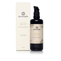 Annmarie presents their coconut body oil, a herb-infused moisturizer for all skin types, alongside its packaging.
