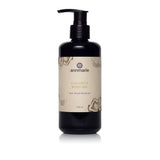 Annmarie Coconut Body Oil herb-infused moisturizer sits on a white surface.
