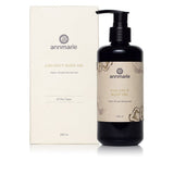 Annmarie presents coconut body oil and its box, advertising a herb-infused moisturizer for all skin types.
