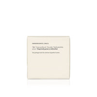 Product packaging lists the natural ingredients, including honey, coconut oil, beeswax, and vanilla extract, of this organically grown skincare product.

