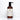 A bottle of Rustic Strength coconut conditioner with lavender and tea tree oil sits on a white marble surface.