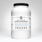 Examine a large container of Rustic Strength Mama & Baby Safe coconut conditioner, unscented and hypoallergenic, crafted with coconut oil and shea butter.
