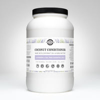 Examine a large container of Rustic Strength coconut conditioner with lavender and tea tree essential oils for normal to dry hair.
