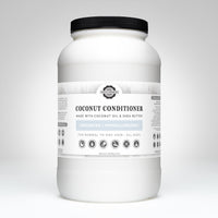 View shows a large, white bottle of Rustic Strength coconut conditioner made with coconut oil and shea butter.
