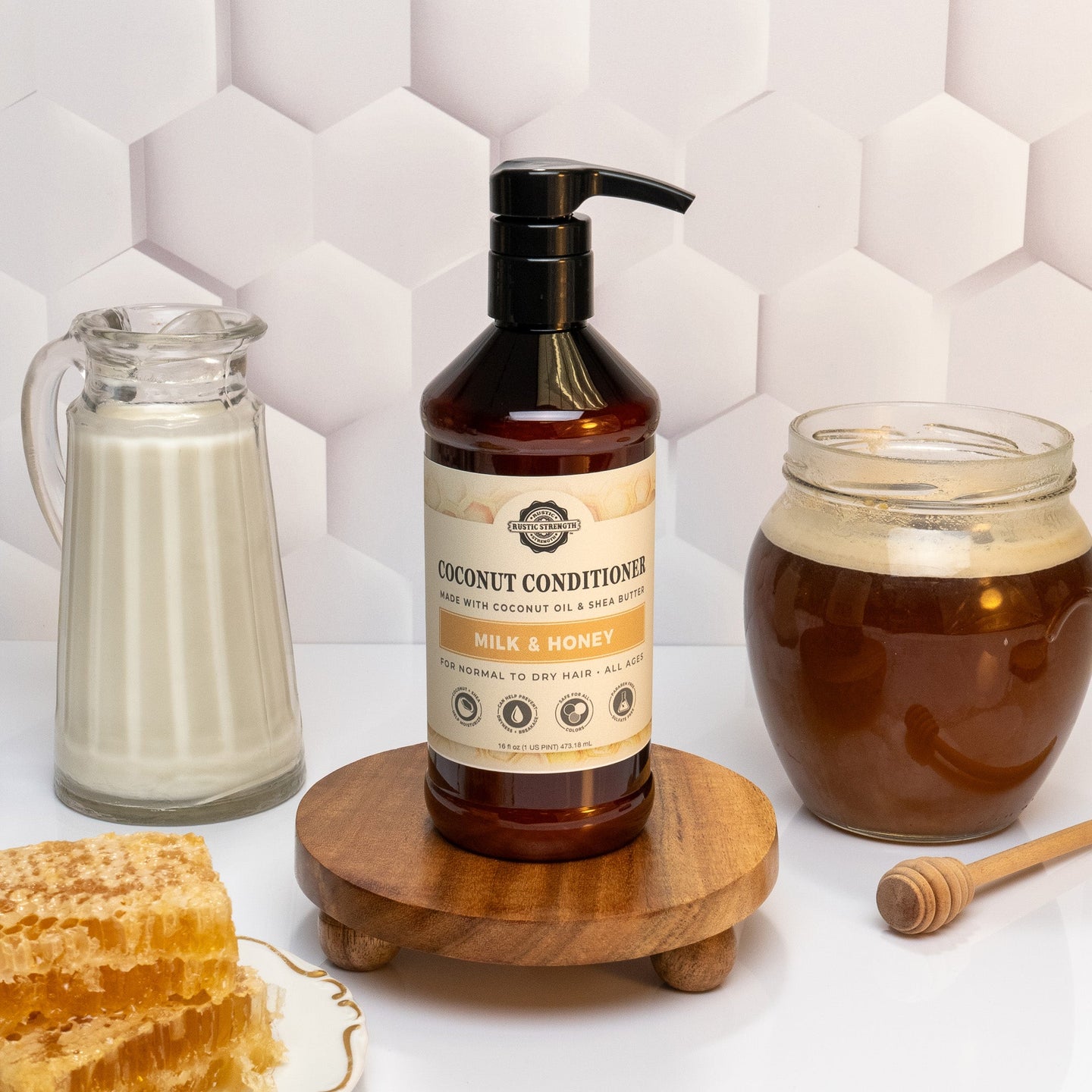 Showcases Rustic Strength Coconut Conditioner Milk & Honey formula alongside milk, honey, and honeycomb.