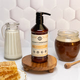 Showcases Rustic Strength Coconut Conditioner Milk & Honey formula alongside milk, honey, and honeycomb.