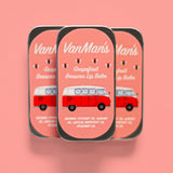Three tins of VanMan's Grapefruit Beeswax Lip Balm feature a retro VW bus design.
