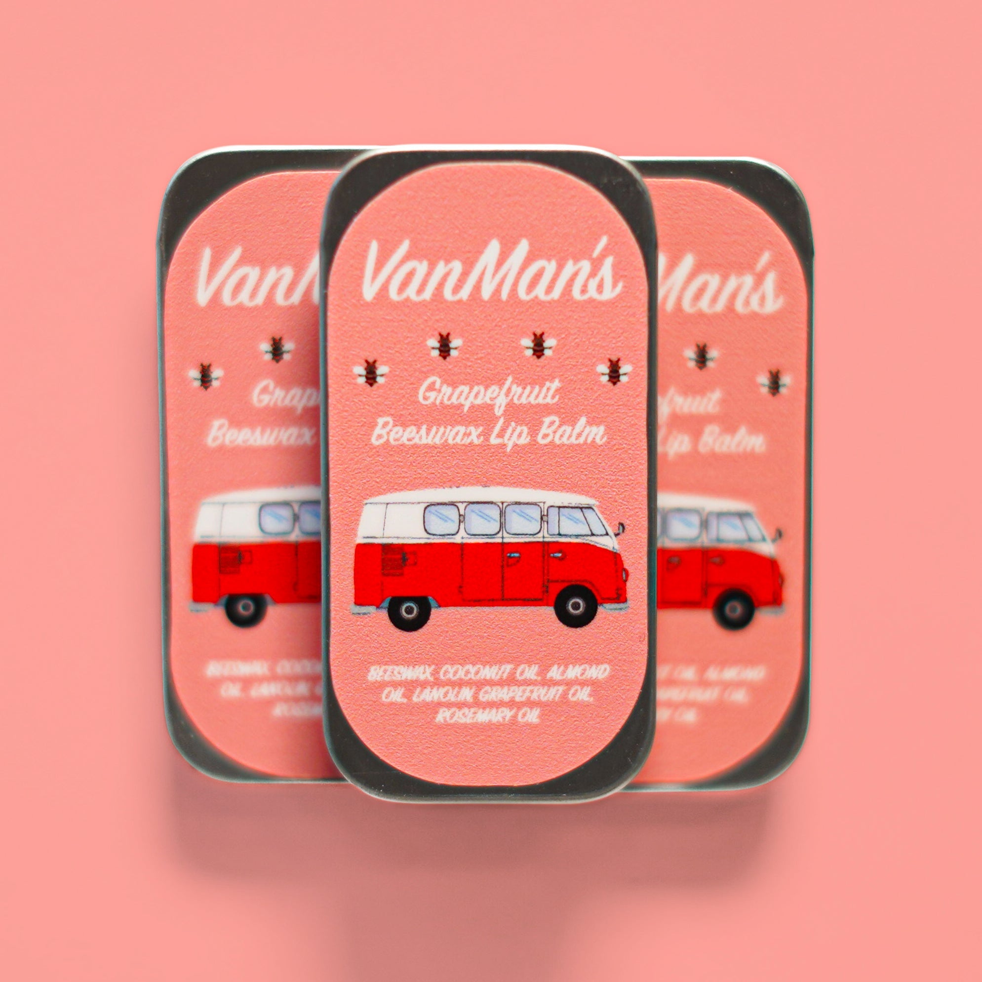 Three tins of VanMan's Grapefruit Beeswax Lip Balm feature a retro VW bus design.
