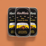 Three tins of VanMan's Bison Beeswax Lip Balm show a bison and a vintage VW bus.
