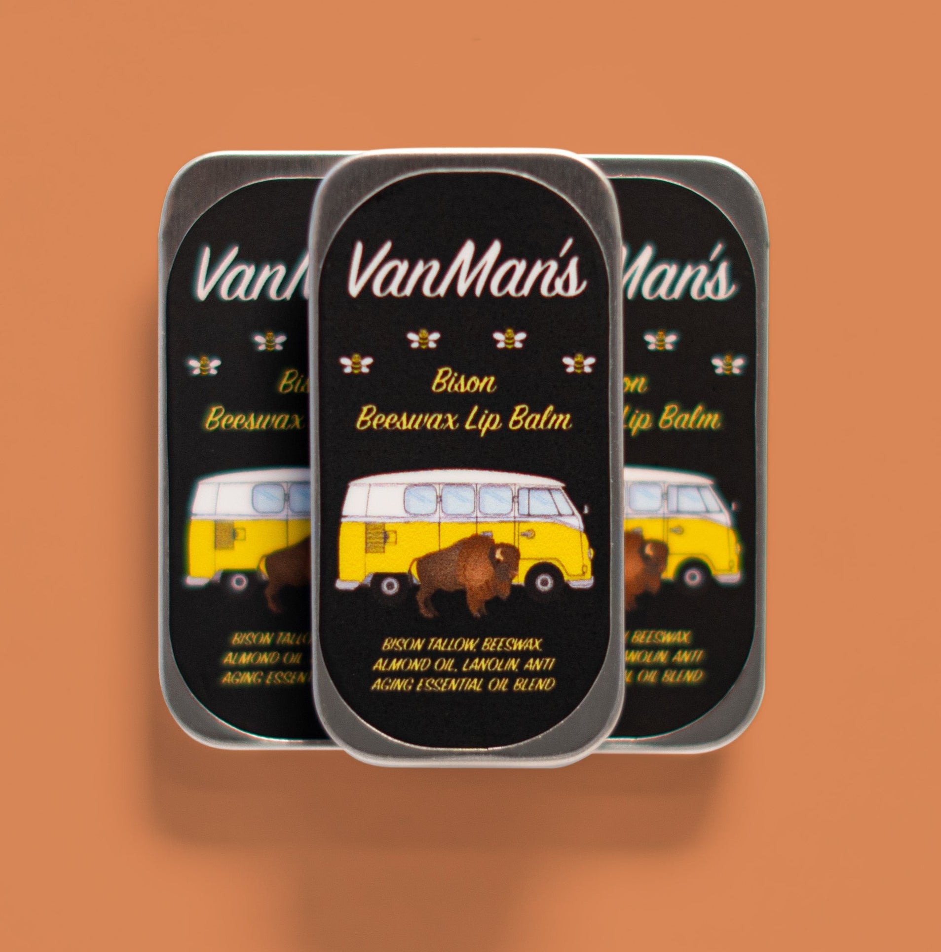 Three tins of VanMan's Bison Beeswax Lip Balm show a bison and a vintage VW bus.
