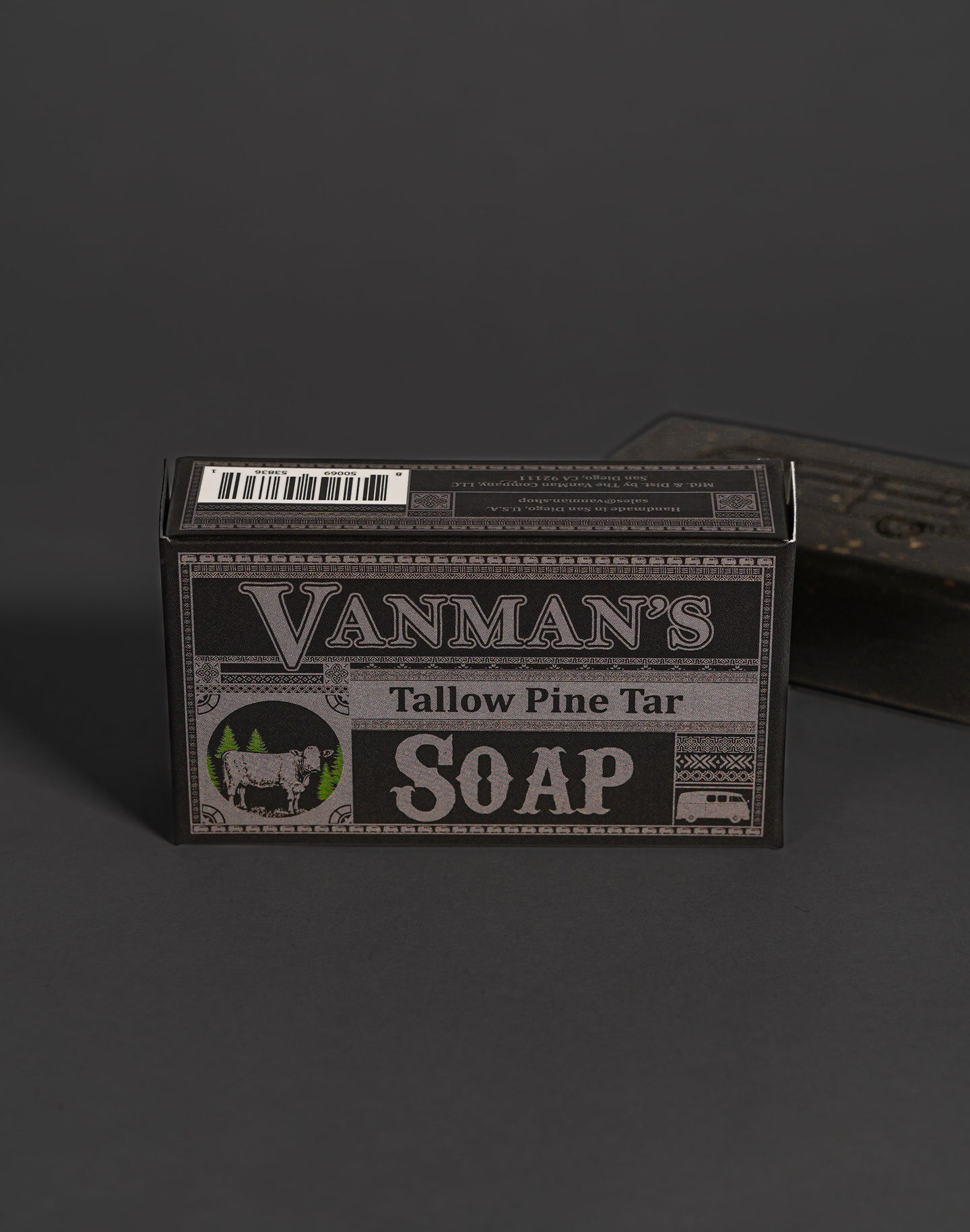 Vanman's Tallow Pine Tar Soap box displays a rustic design featuring a cow and pine trees.

