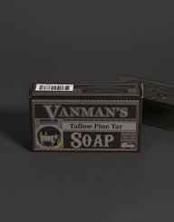 Vanman's Tallow Pine Tar Soap box displays a rustic design featuring a cow and pine trees.
