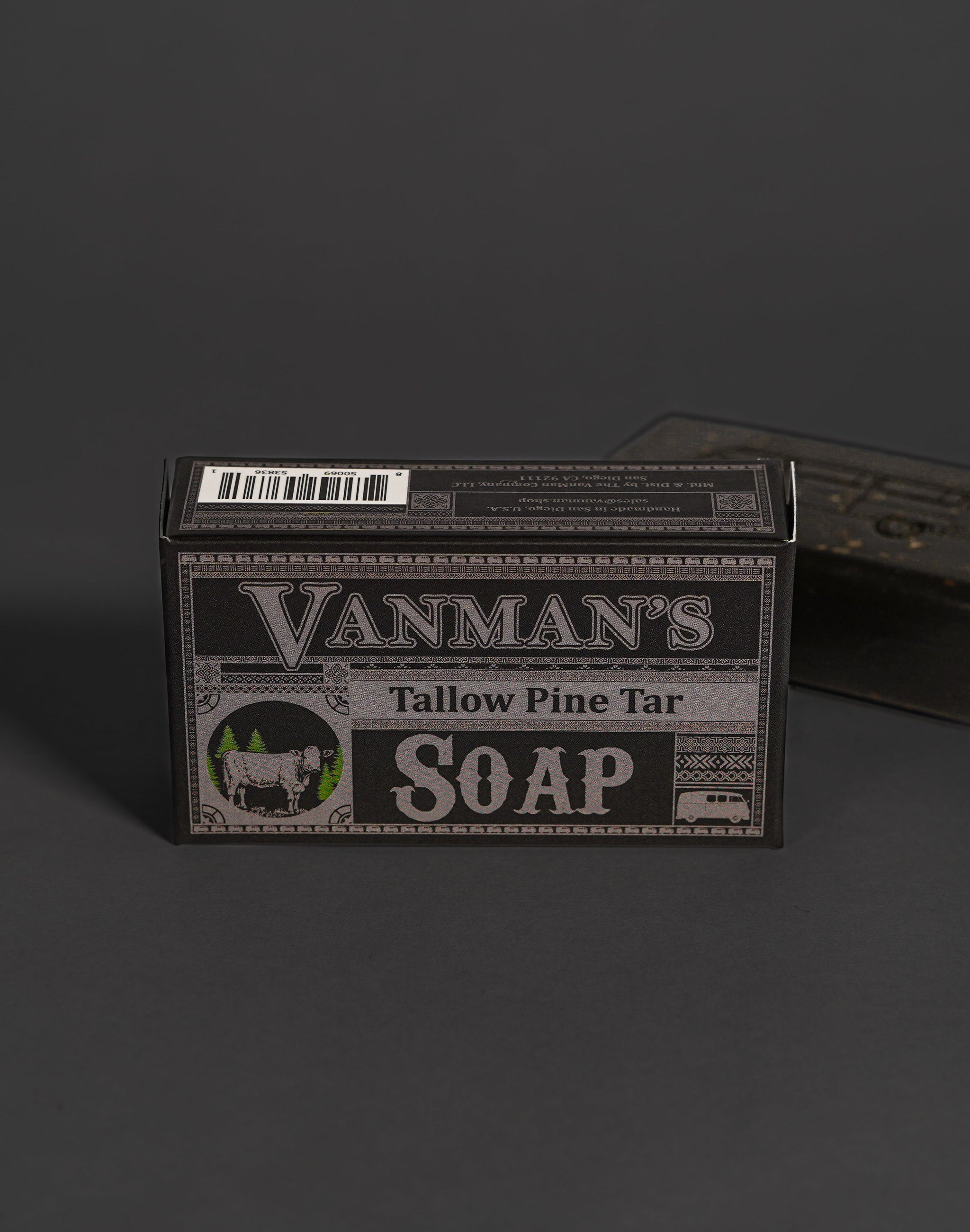 Vanman's Tallow Pine Tar Soap box displays a rustic design featuring a cow and pine trees.

