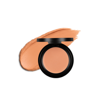 An open, compact concealer shows the product alongside a swatch of the creamy makeup.
