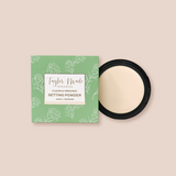 Display shows Taylor Made Organics clean setting powder compact next to its green floral box.
