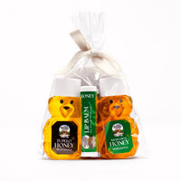 Two honey bear bottles, filled with tupelo honey and wildflower honey, and honey lip balm, come in a gift bag.