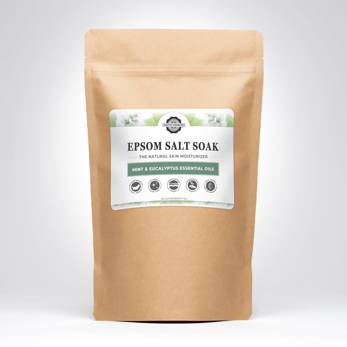 A kraft paper bag displays Rustic Strength Epsom Salt Soak with mint and eucalyptus essential oils for natural skin moisturizing.
