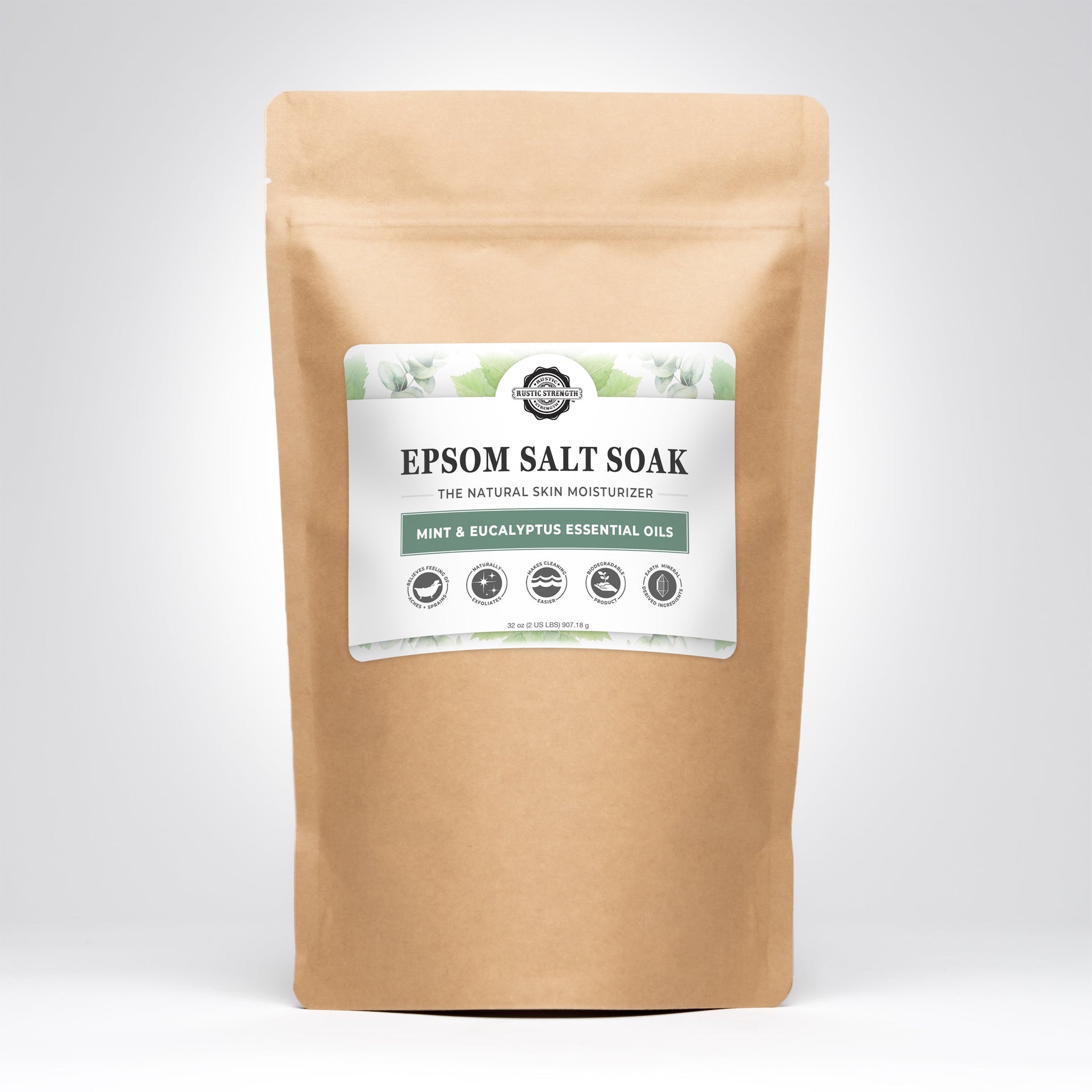 A kraft paper bag displays Rustic Strength Epsom Salt Soak with mint and eucalyptus essential oils for natural skin moisturizing.
