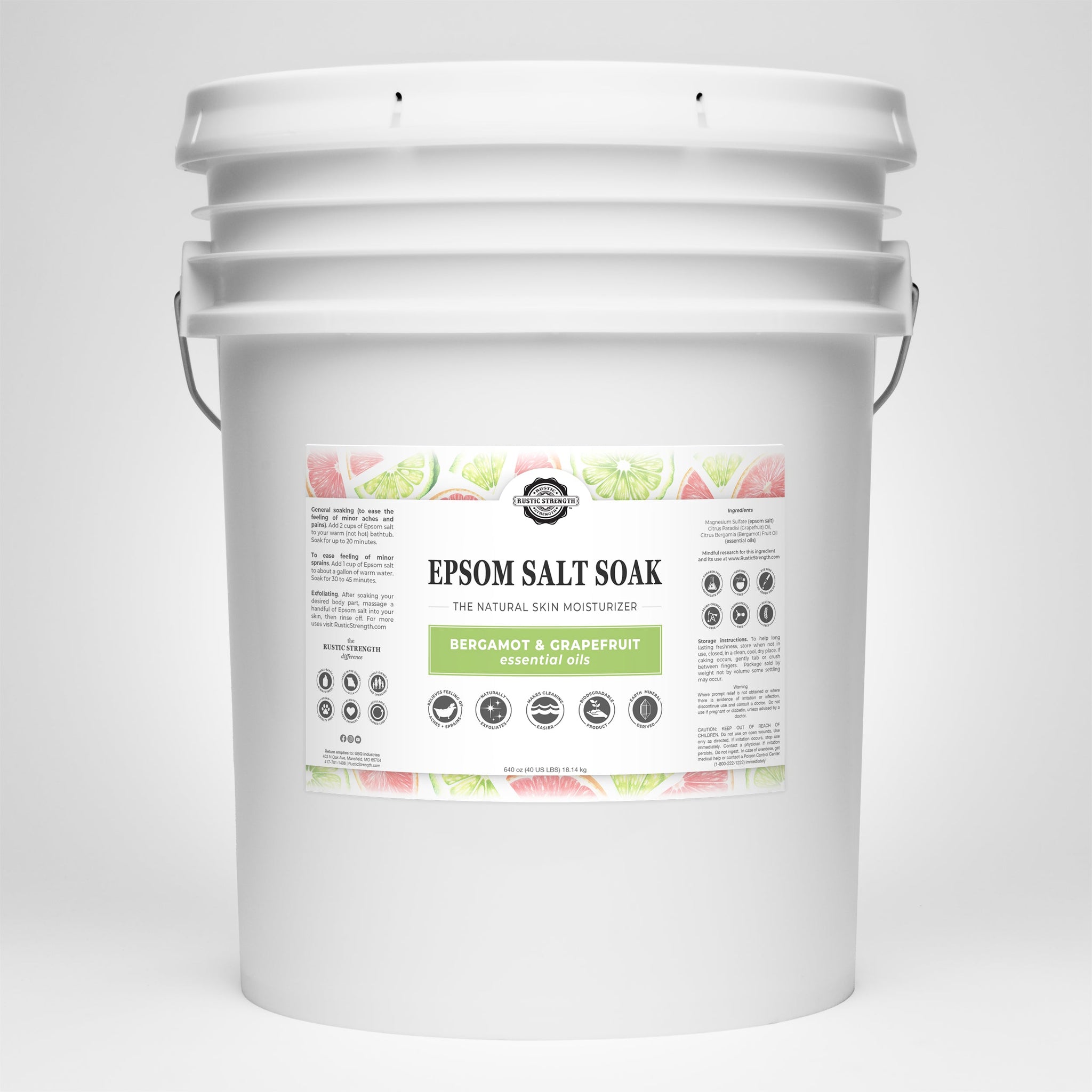 Examine a large white bucket filled with Rustic Strength Epsom Salt Soak, featuring bergamot and grapefruit essential oils for natural skin moisturizing.
