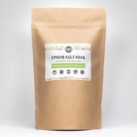 A kraft bag showcases Rustic Strength Epsom Salt Soak, a natural skin moisturizer with bergamot and grapefruit essential oils.
