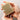 Hand holding a bar of soap with lather on a neutral background