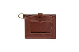 Showcases a brown leather ID card holder with a snap closure and a gold keyring.
