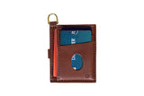 Showcases a brown leather minimalist wallet holding several credit cards and featuring a convenient gold keychain ring.
