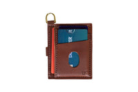 Showcases a brown leather minimalist wallet holding several credit cards and featuring a convenient gold keychain ring.
