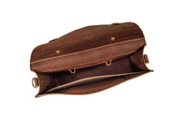 An open, brown leather briefcase displays its spacious interior and secure hardware.
