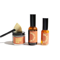 Showcase URB Apothecary skincare products, including Charcoal Burdock Mask with application brush, Lavender Milky Oat, and Sun Worshiper oils.
