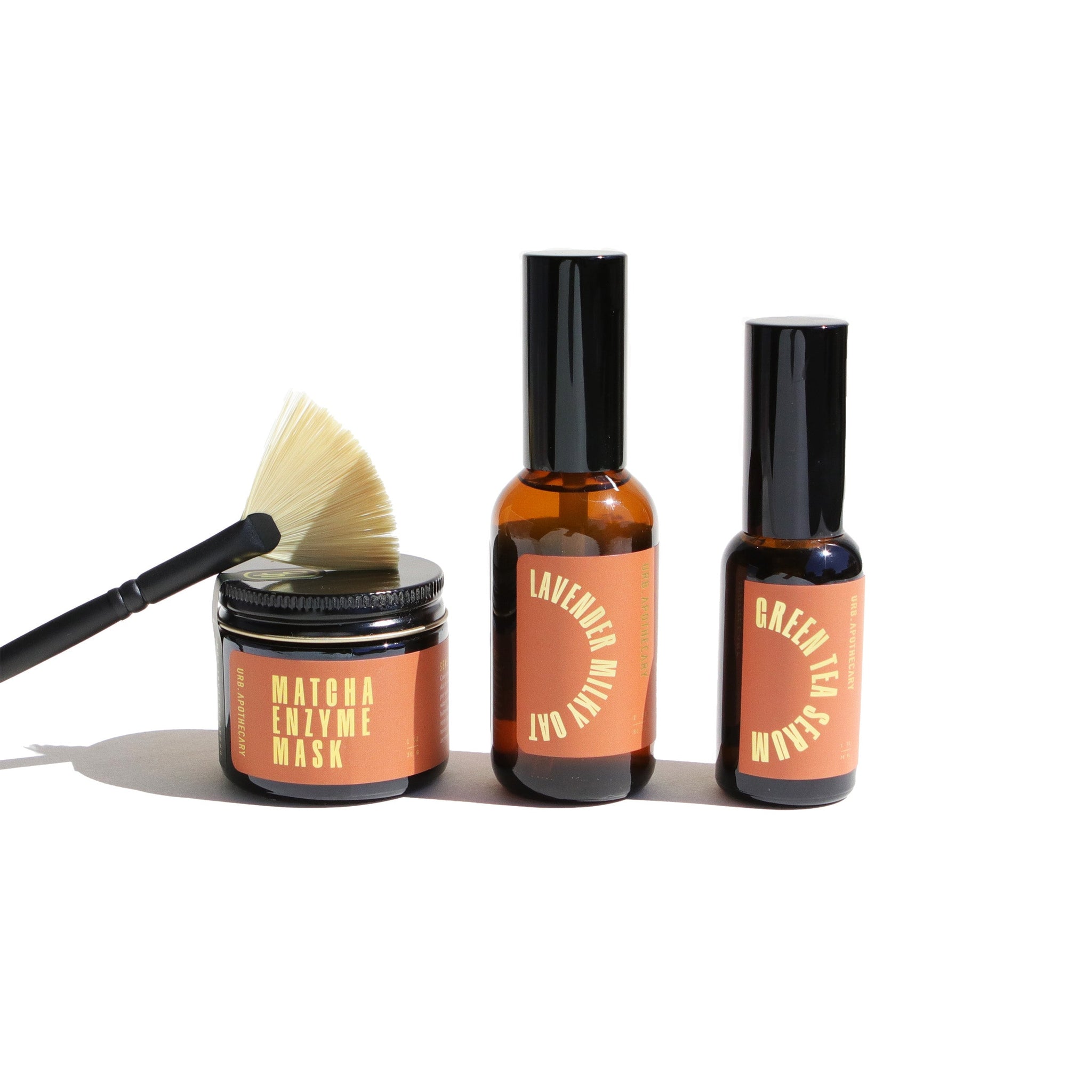 Urb Apothecary showcases its matcha enzyme mask, lavender milky oat, and green tea serum with a sleek brush.

