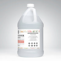 A gallon jug displays plant-based cleaner concentrate with grapefruit essential oils for sealed floors, promoting toxin-free cleaning.

