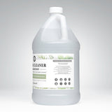A gallon jug displays plant-based floor cleaner concentrate with tea tree essential oils, emphasizing toxin-free and powerful cleaning.
