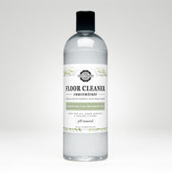 Bottle displays Rustic Strength floor cleaner concentrate, a plant-based, rosemary mint and tea tree essential oil cleaning product.
