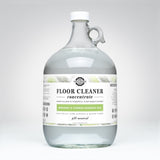 Rustic Strength's plant-based floor cleaner concentrate, infused with bergamot and cypress essential oils, comes in a reusable one-gallon glass jug.
