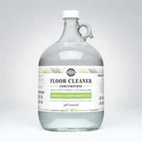 Rustic Strength's plant-based floor cleaner concentrate, infused with bergamot and cypress essential oils, comes in a reusable one-gallon glass jug.
