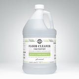 Showcases a gallon jug of Rustic Strength floor cleaner concentrate with bergamot and cypress essential oils.
