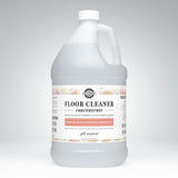 A gallon jug of Rustic Strength floor cleaner concentrate promises plant-based cleaning with lemon, lime, orange, and grapefruit essential oils.
