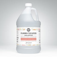 A gallon jug of Rustic Strength floor cleaner concentrate promises plant-based cleaning with lemon, lime, orange, and grapefruit essential oils.