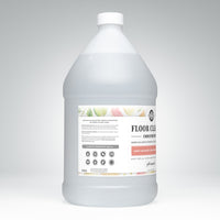 A gallon jug showcases Rustic Strength Floor Cleaner Concentrate with lemon, lime, orange, and grapefruit scents for a safe and effective hard surface cleaning solution.
