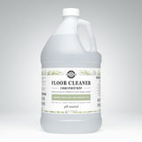 Shows a gallon jug of Rustic Strength floor cleaner concentrate with rosemary, mint, and tea tree essential oils.
