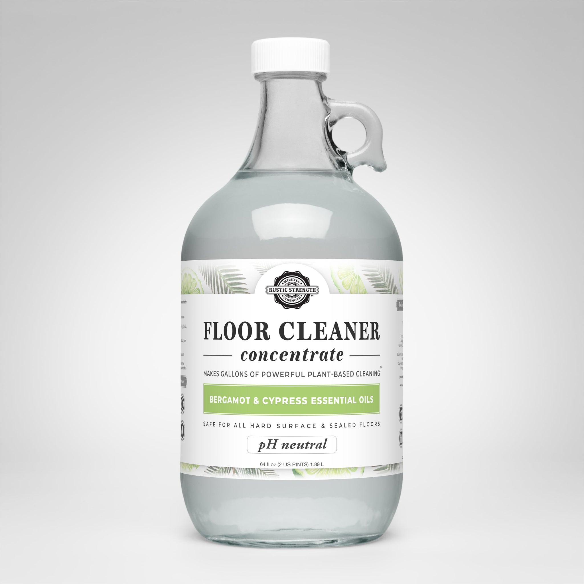 View showcases a glass jug of Rustic Strength floor cleaner concentrate featuring bergamot and cypress essential oils.
