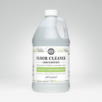 A bottle of Rustic Strength plant-based floor cleaner concentrate boasts bergamot and cypress essential oils.
