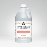 A bottle of Rustic Strength floor cleaner concentrate boasts its plant-based formula with lemon, lime, orange, and grapefruit essential oils.
