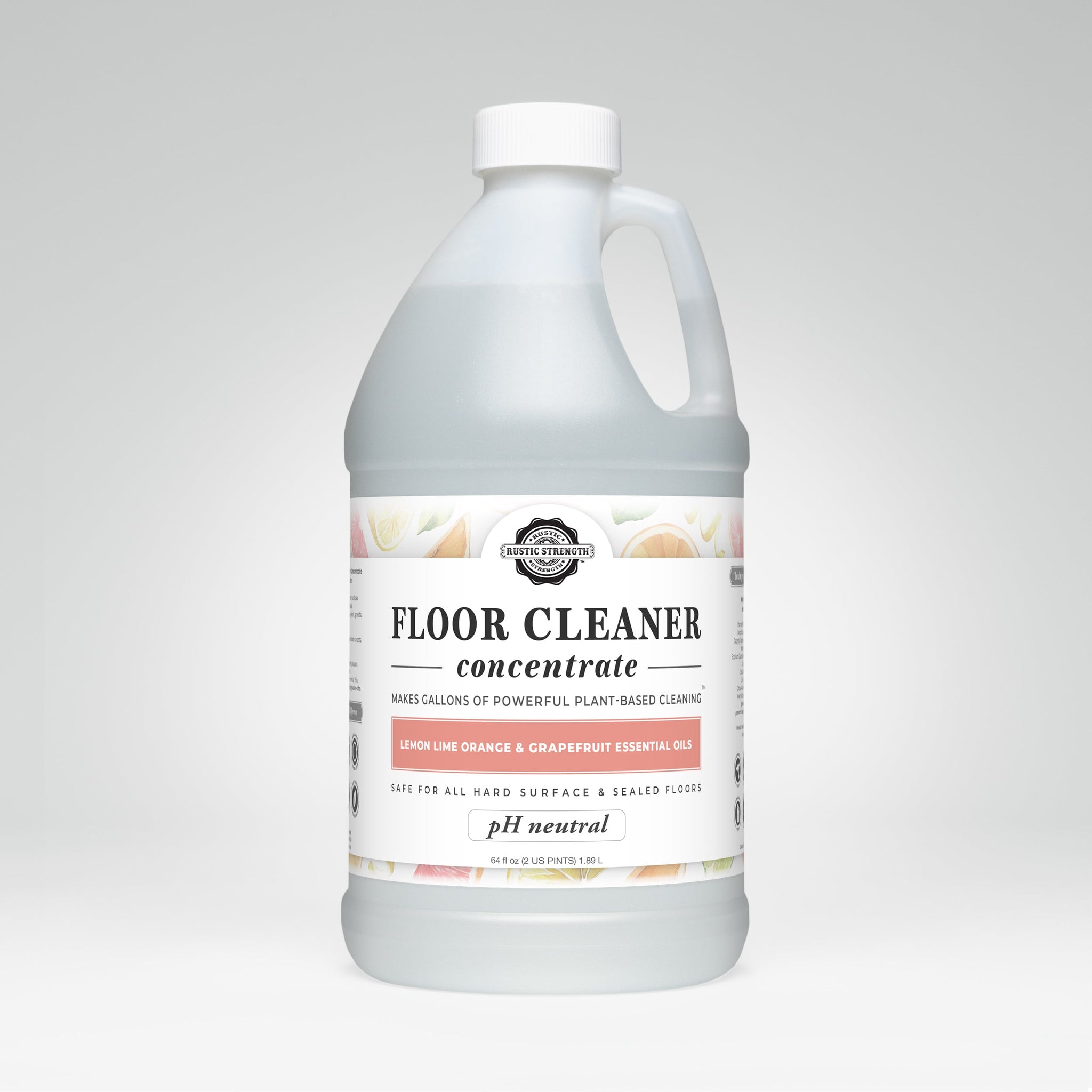 A bottle of Rustic Strength floor cleaner concentrate boasts its plant-based formula with lemon, lime, orange, and grapefruit essential oils.
