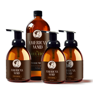 American Maid's plant-based foaming hand soap and all-purpose cleaner bottles sit arranged against a black background.
