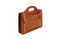 A handcrafted brown leather briefcase showcases its unique handle design and detailed front pocket on a white background.
